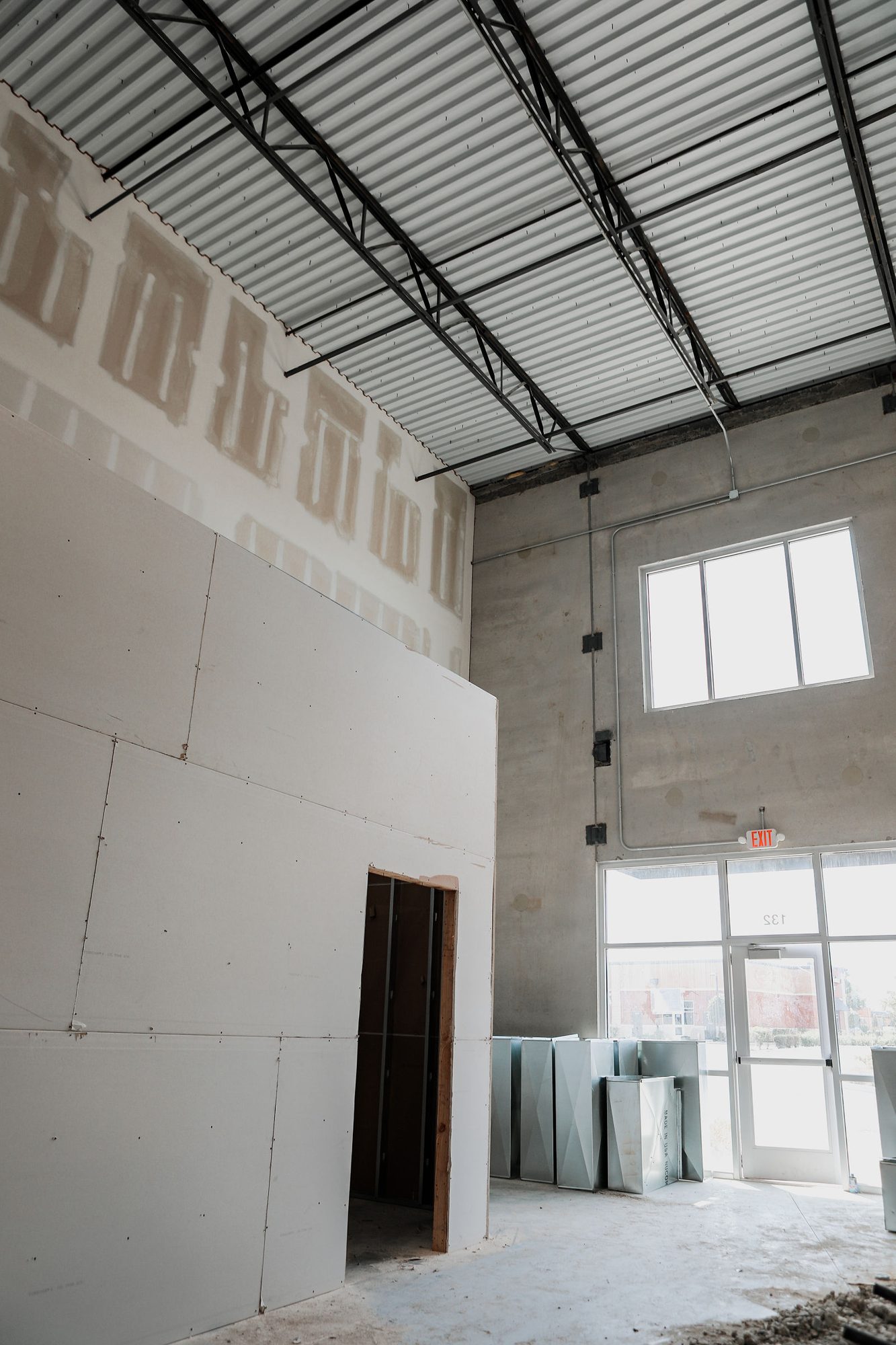 New interior partitions in a high-bay space during an Indianapolis-area commercial build-out