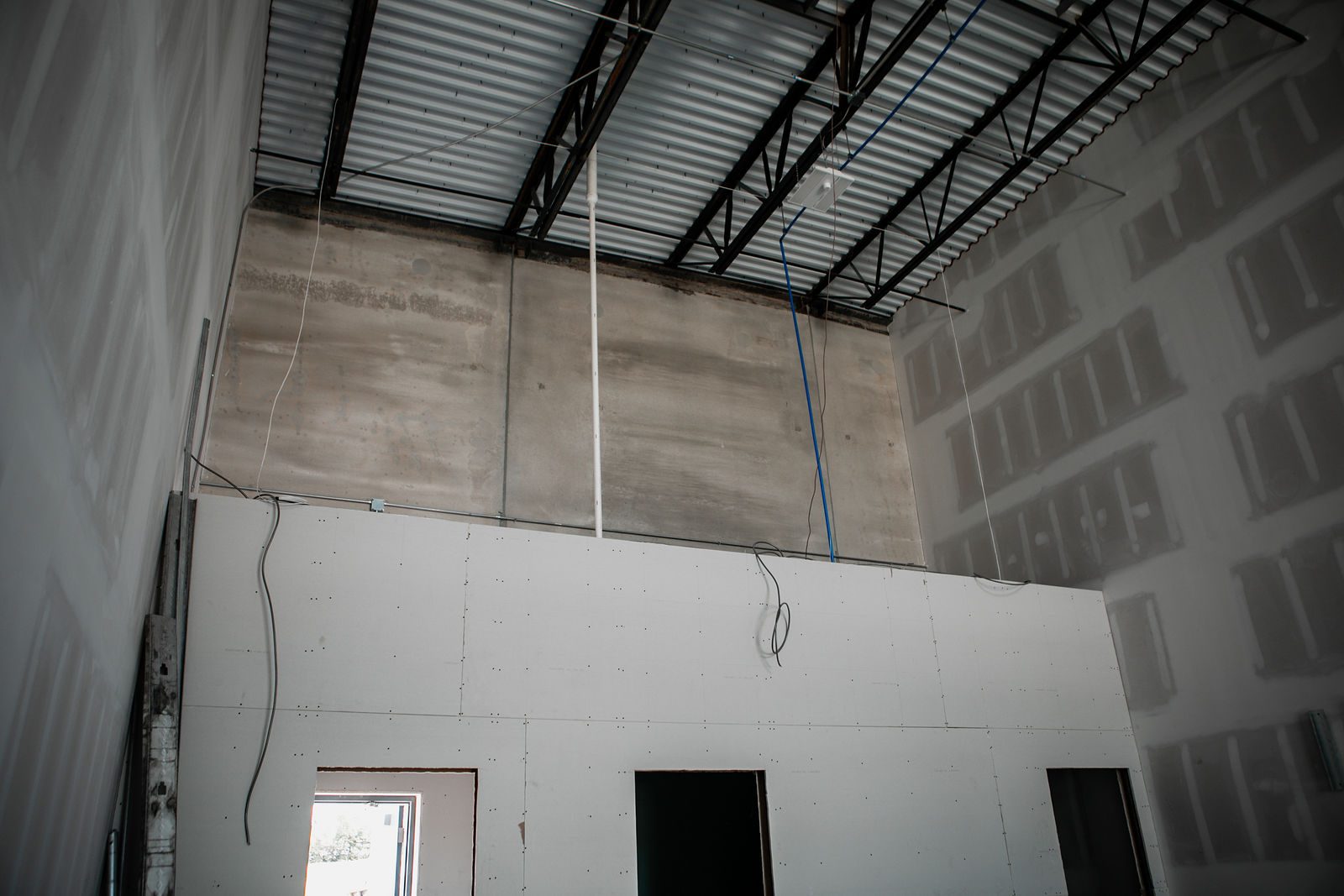 Drywall going up on a mezzanine in an Indianapolis-area commercial build-out
