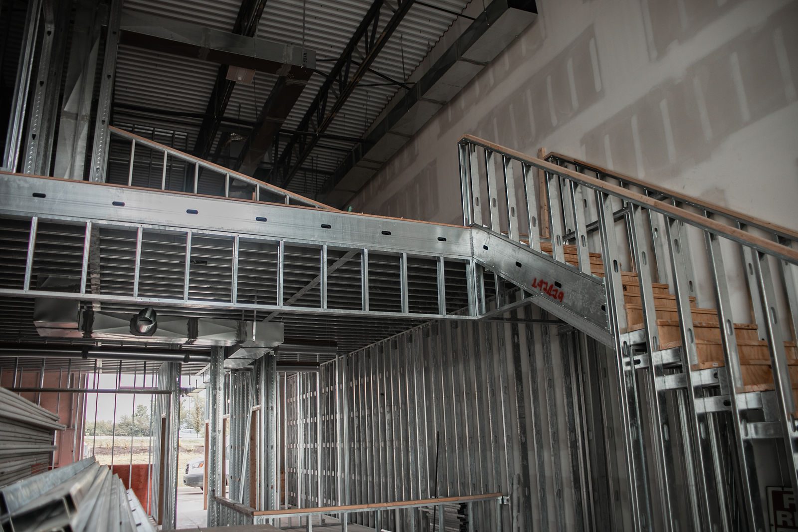 Steel stair and mezzanine framing during an Indianapolis-area commercial build-out